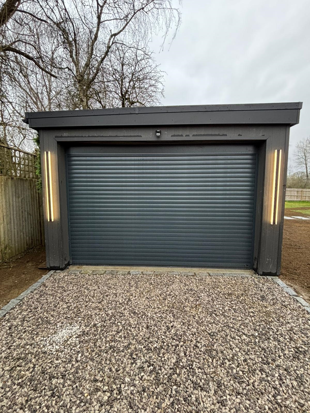 Dark-clad outbuilding with insulated shell by Cruise Construction